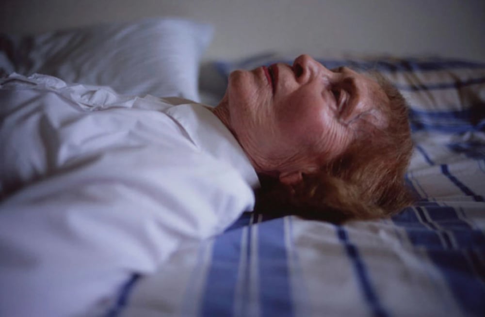 My mother laying on her bed. Salem. 2005. © Nan Goldin.